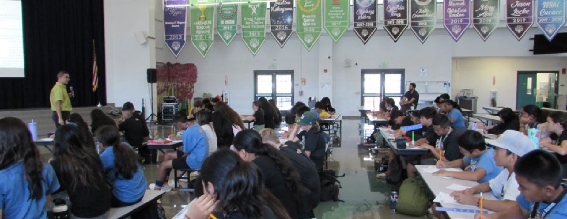 Volunteer attorney speaking with students in a Hawaiʻi public school classroom