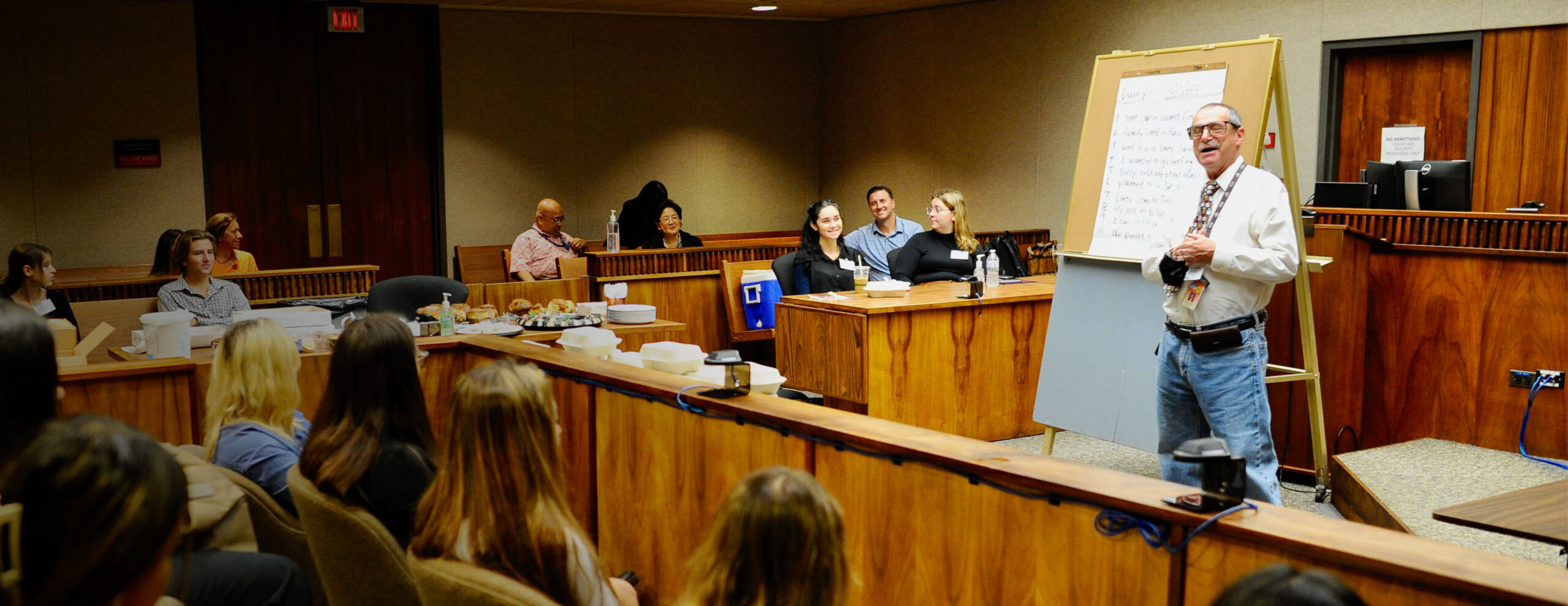 High school students seated at counsel tables during a Law & Justice Academy mock trial in a Hawaiʻi courtroom