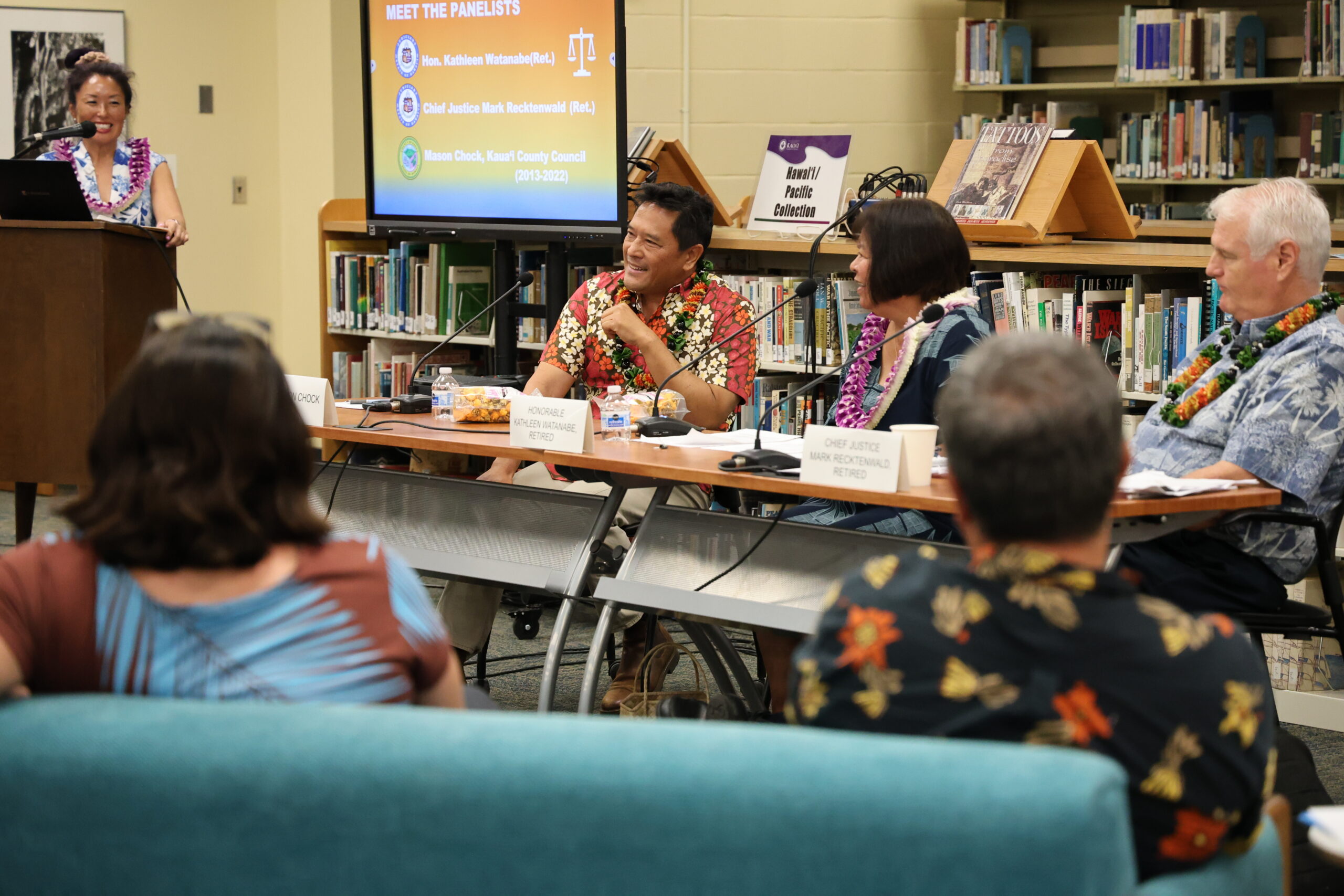 Panelists Mason Chock, Hon. Kathleen Watanabe (Ret.), and Chief Justice Mark Recktenwald (Ret.) at the KCC Library forum, with moderator Jenny Silbiger at the podium