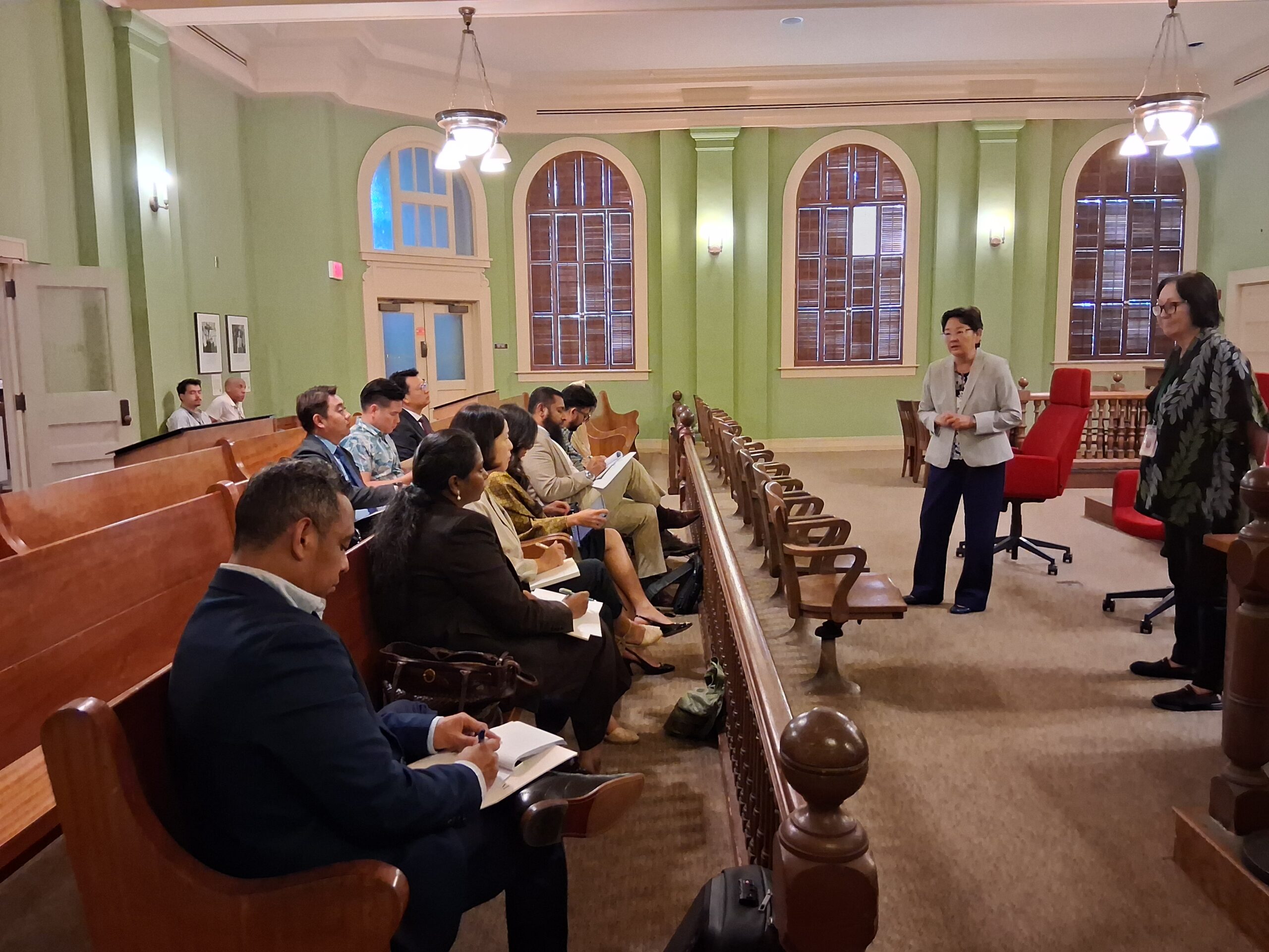 Delegates seated in the 1913 Courtroom listening to a Hawaiʻi Supreme Court justice